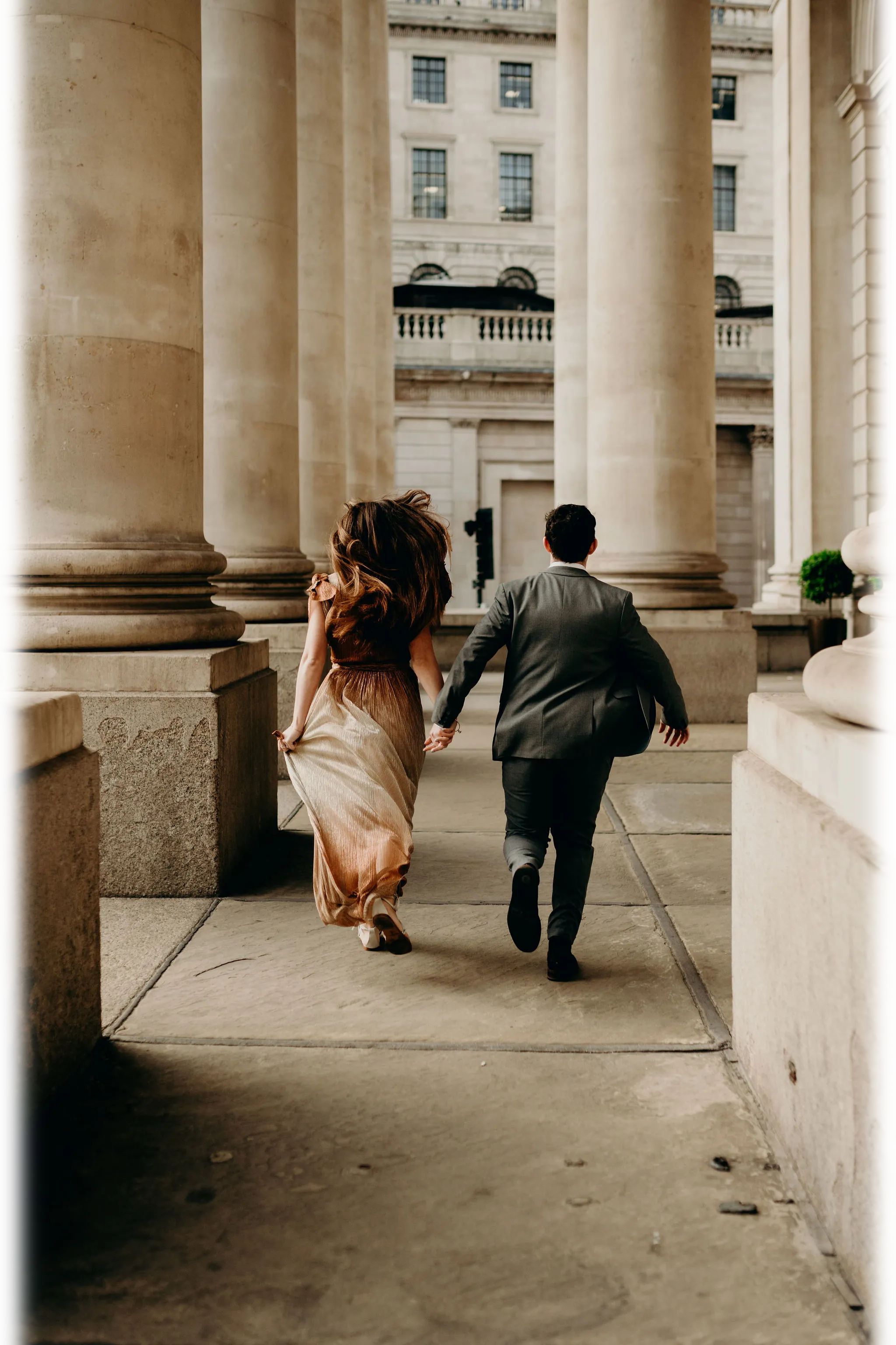 Wedding couple running away from the camera